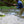 Angler mid-drift on a small wooded stream in the Approach Hoodie in Blue Run and Approach Pants in Freestone