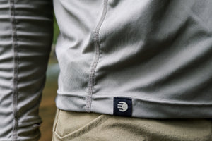 Close-up of the woven ETHIC label and stitching at the hem of the Approach Hoodie in Hemlock